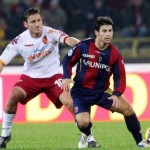 Davide Carrus, con la maglia del Bologna, pressato da Francesco Totti